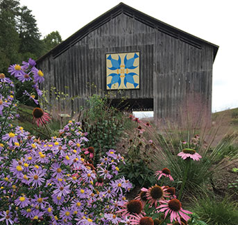 Photo of a barn and some flowers. Links to Gifts from Retirement Plans page.