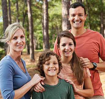 Photo of a family smiling. Links to Gifts of Real Estate page.