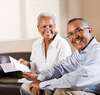 Photo of couple with papers. Links to Closely Held Business Stock page.