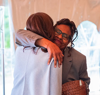 Photo of two people hugging. Link to What to Give.