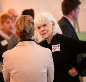 Photo of two woman talking. Links to Gifts of Appreciated Securities page.