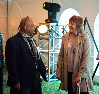 Photo of two people talking by light post. Links to Gifts of Life Insurance page.